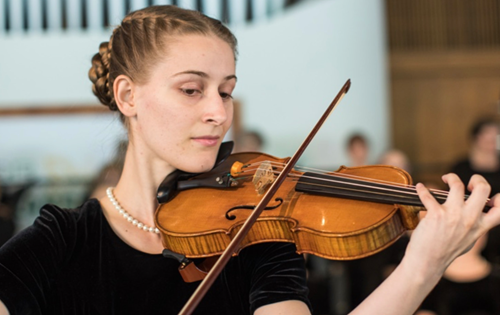 Concordia student pictured performing on violin.